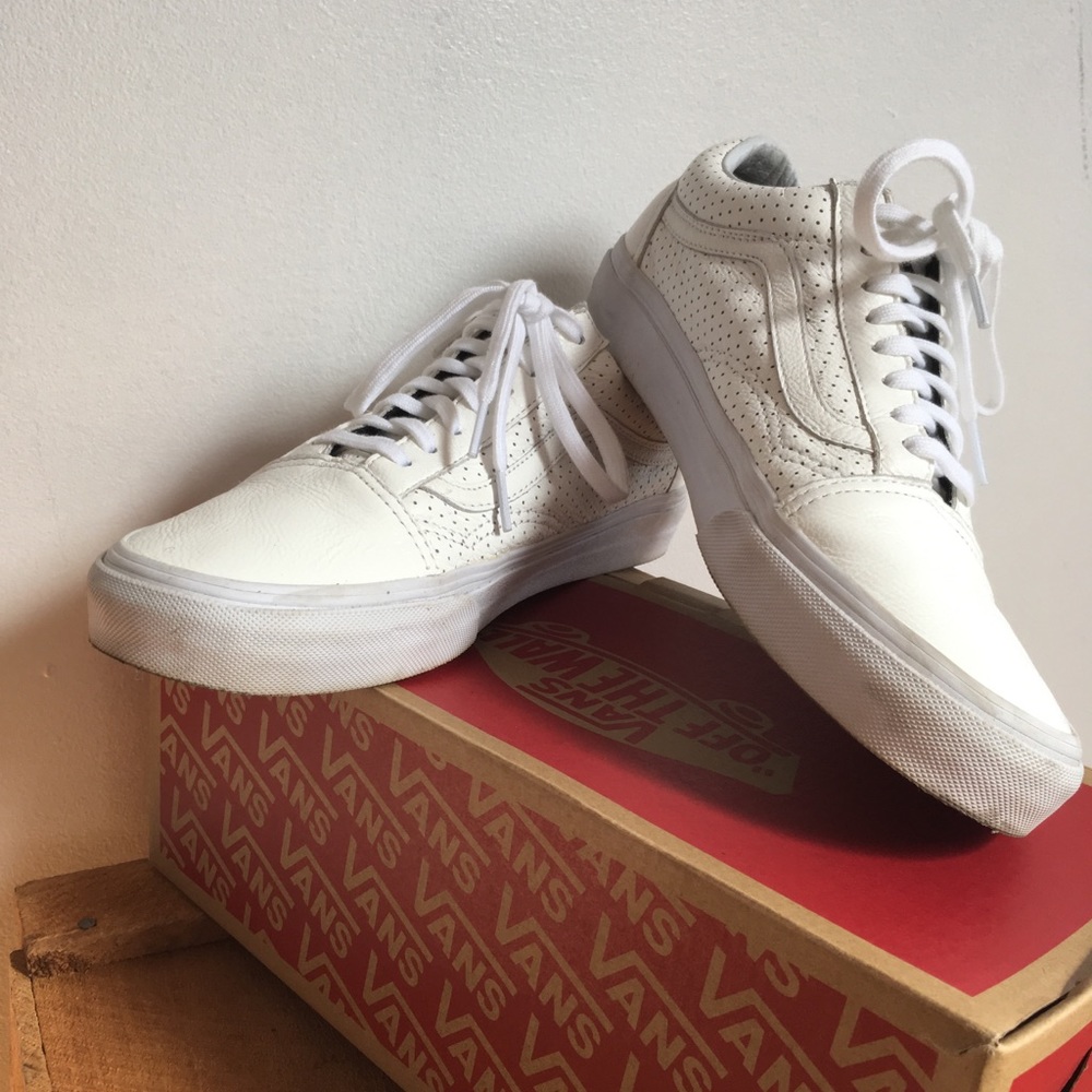 Zippered white Vans sneakers
